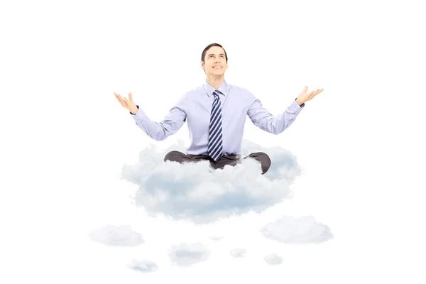 Young businessman sitting on a cloud — Stock Photo, Image