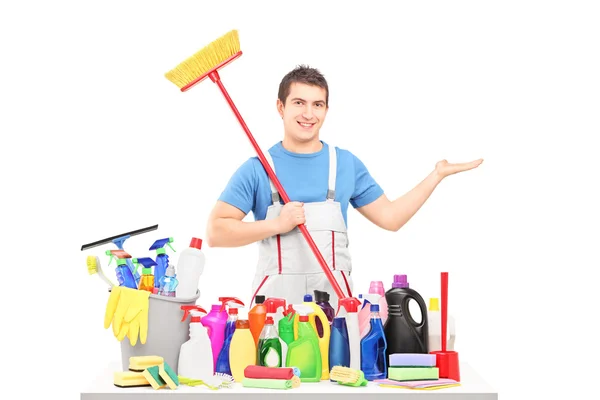 Man in uniform with cleaning supplies — Stock Photo, Image