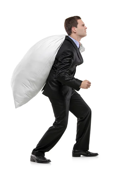 Businessman carrying money bag — Stock Photo, Image