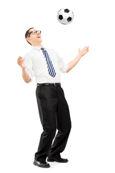 Businessman playing with a soccer ball — Stock Photo, Image