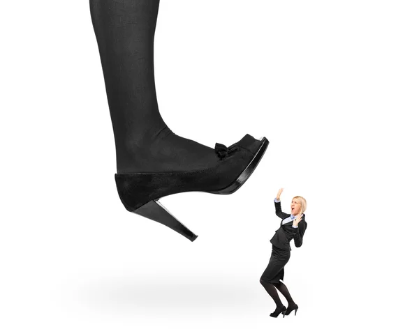 Zapato de mujer pisando mujer de negocios — Foto de Stock