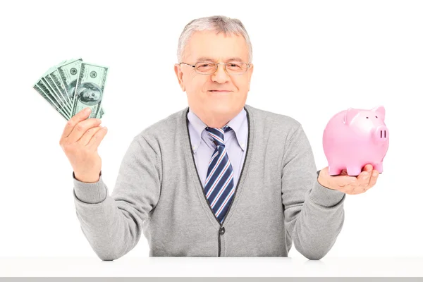 Man holding money and piggy bank — Stock Photo, Image