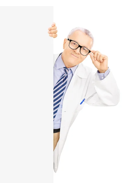 Doctor standing next to blank panel — Stock Photo, Image