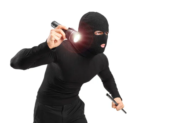 Robber with flashlight and pipe — Stock Photo, Image