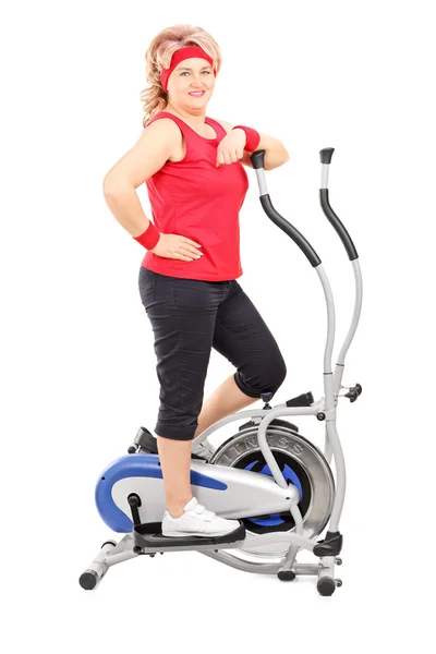 Lady on cross trainer machine — Stock Photo, Image