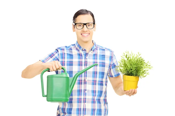 Uomo che tiene annaffiatoio e vaso da fiori — Foto Stock