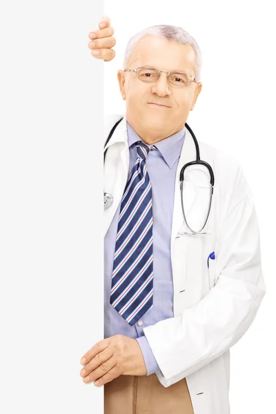 Doctor standing next to blank panel — Stock Photo, Image