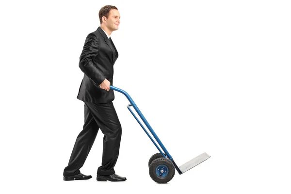 Businessman pushing an empty handtruck — Stock fotografie