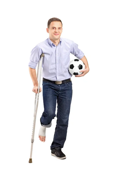 Injured young man on crutches — Stock Photo, Image