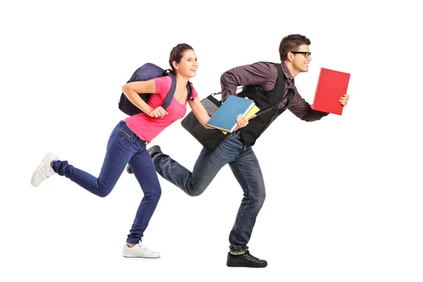 Students rushing forwards with books — Stock Photo, Image