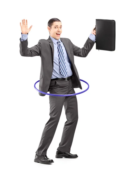 Businessman dancing with hula hoop — Stock Photo, Image