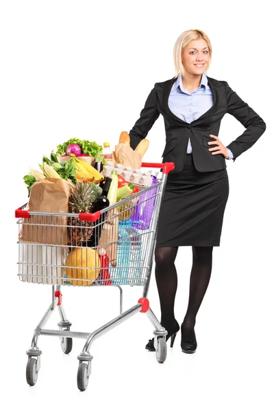 Woman next to shopping cart — Stock Photo, Image