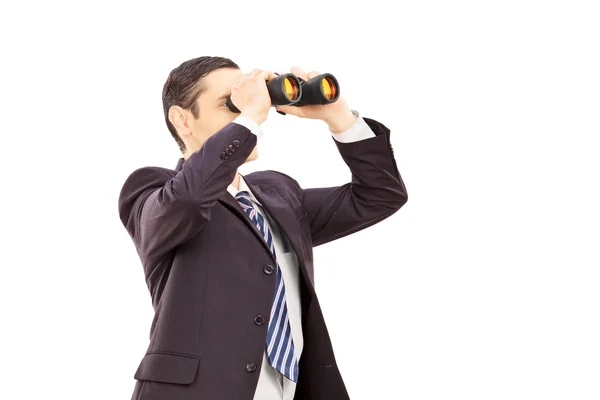 Businessman looking through binoculars — Stock Photo, Image