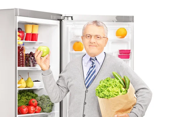 Mature man holding paper bag — Stock Photo, Image