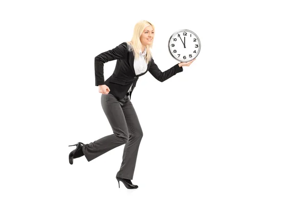 Businesswoman running with clock — Stock Photo, Image