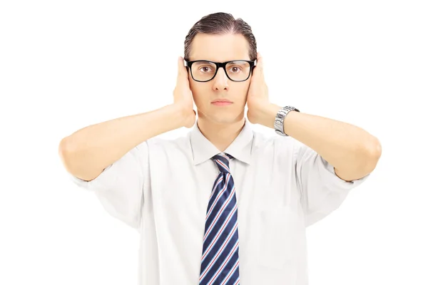 Man with glasses covering ears with hands — Zdjęcie stockowe