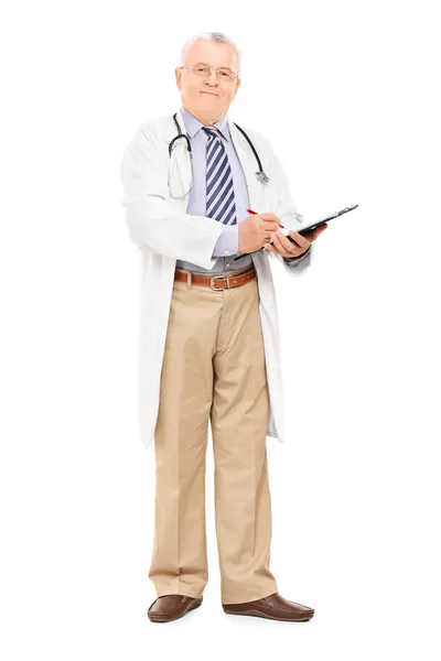 Male doctor writing on clipboard — Stock Photo, Image
