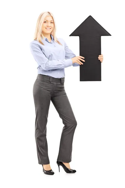 Blond smiling woman holding arrow — Stock Photo, Image