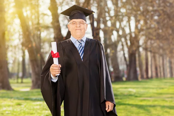 Mature student holding a diploma — Stock Photo, Image