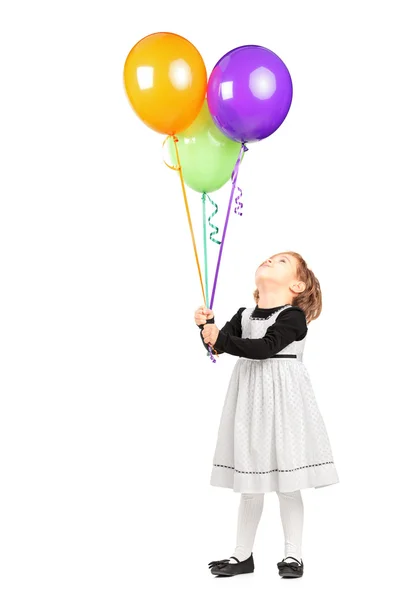 Chica mirando montón de globos — Foto de Stock