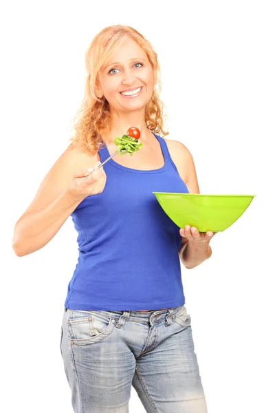 Mature smiling woman eating salad — Stock Photo, Image