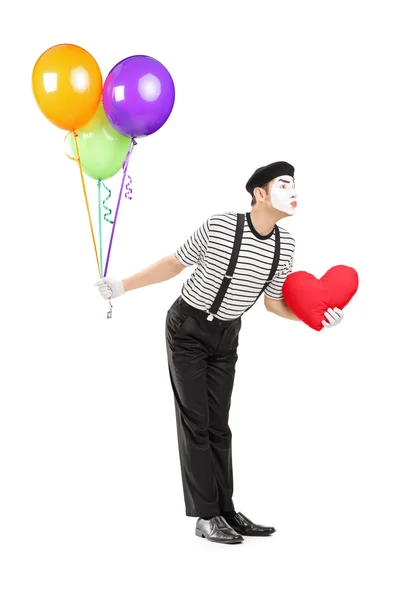 Mime artist with balloons giving kisses — Stock Photo, Image