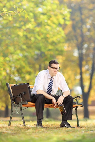 Disappointed businessman with bottle — Stock Photo, Image