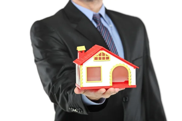 Real estate agent holding model house — Stock Photo, Image