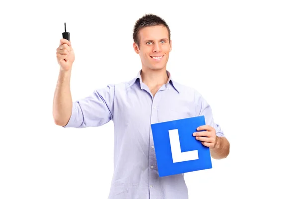 Man holding car key and L plate — Stock Photo, Image