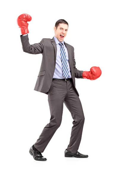 Businessman wearing red boxing gloves — Stock Photo, Image