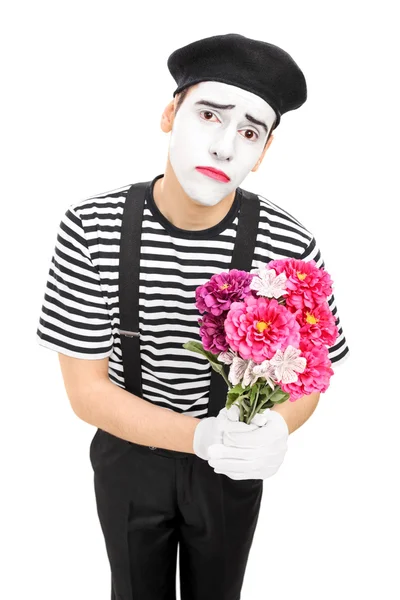 Sad mime artist holding bouquet — Stock Photo, Image