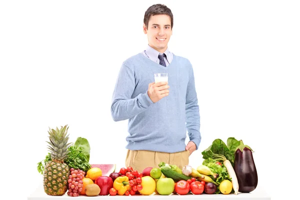 Man standing next to pile of food — Stock Photo, Image