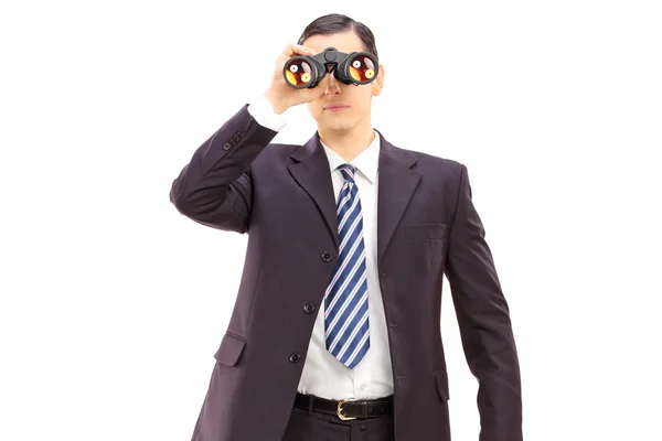Businessman watching through binoculars — Stock Photo, Image