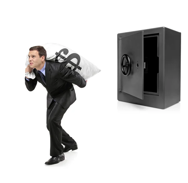 Businessman stealing money bag — Stock Photo, Image