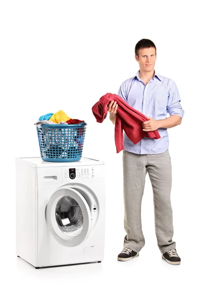 Man holding blouse and washing machine — Stock Photo, Image