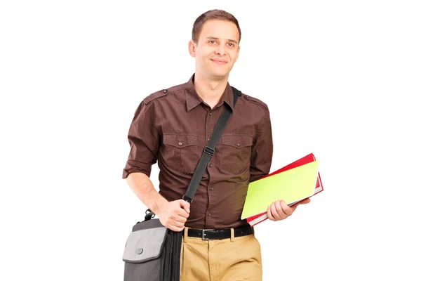 Young man walking with books — Stock Photo, Image