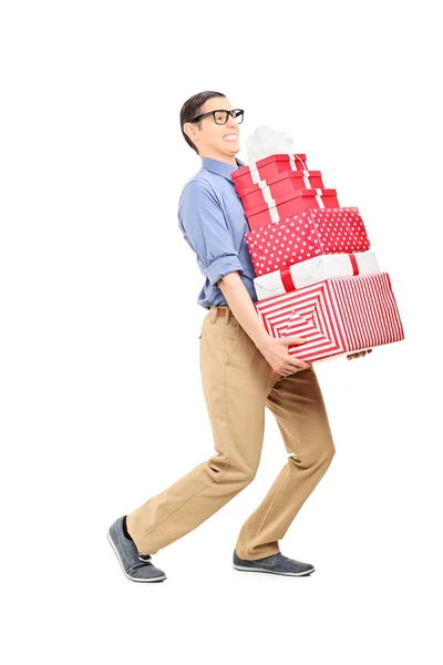 Man carrying heavy load of presents — Stock Photo, Image