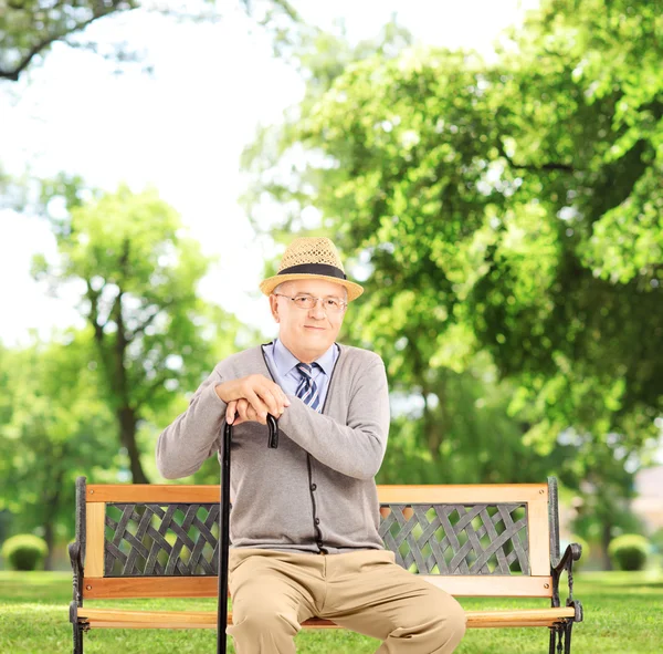 Старший на скамейке в парке — стоковое фото