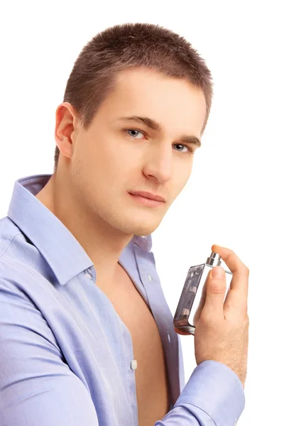 Young man spraying perfume — Stock Photo, Image