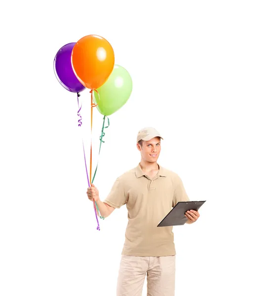 Delivery boy delivering balloons — Stock Photo, Image