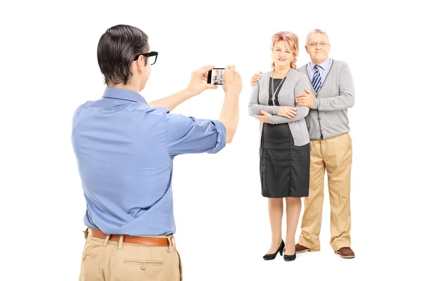 Hombre tomando fotos de una pareja madura — Foto de Stock