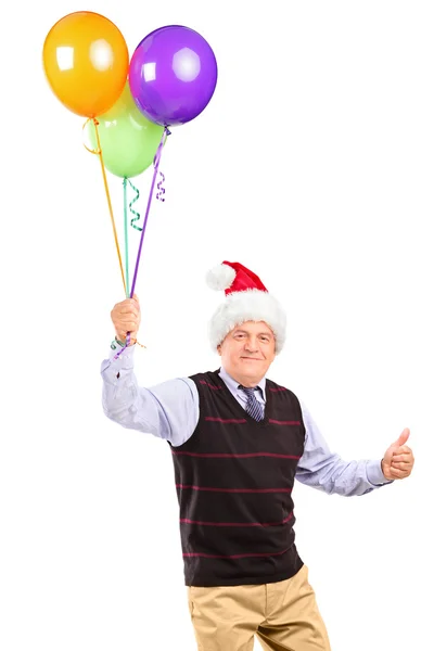 Pán s kloboukem drží balónky — Stock fotografie