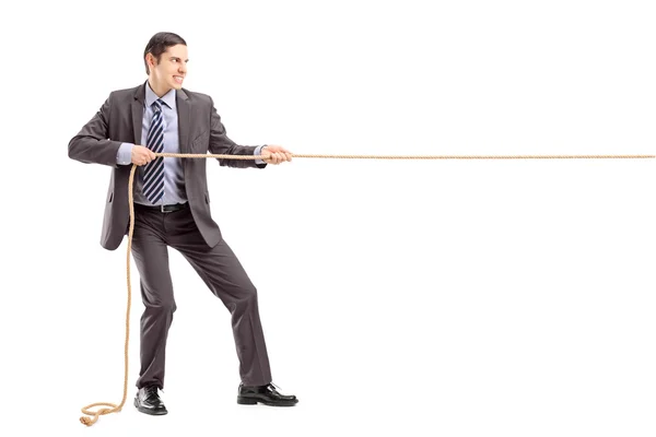 Businessman pulling rope — Stock Photo, Image