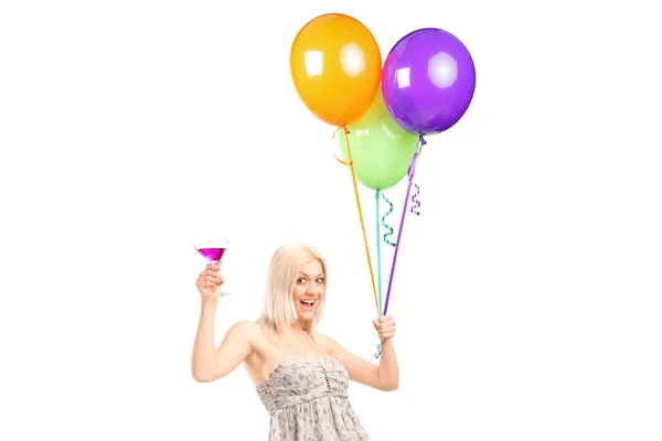 Woman holding balloons and cocktail — Stock Photo, Image
