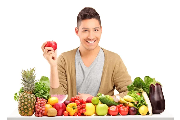 Handsome guy holding an apple — Stock Photo, Image
