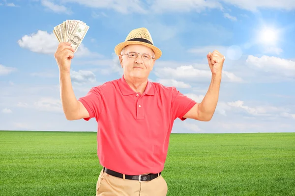 Старший чоловік тримає гроші — стокове фото
