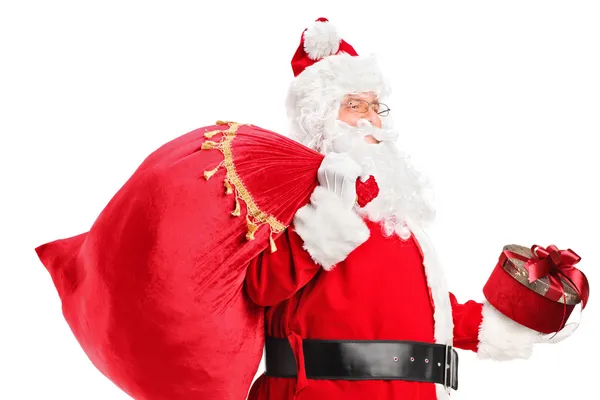 Santa Claus carrying bag — Stock Photo, Image