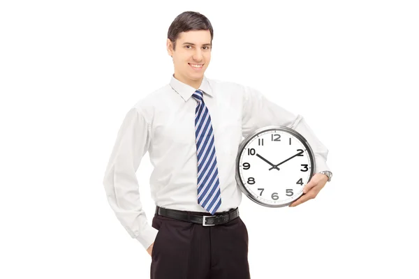 Chlap v obleku drží hodiny — Stock fotografie