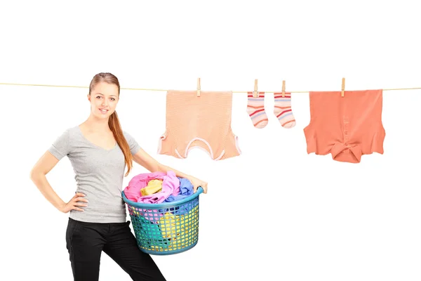 Woman holding laundry basket — Stock Photo, Image