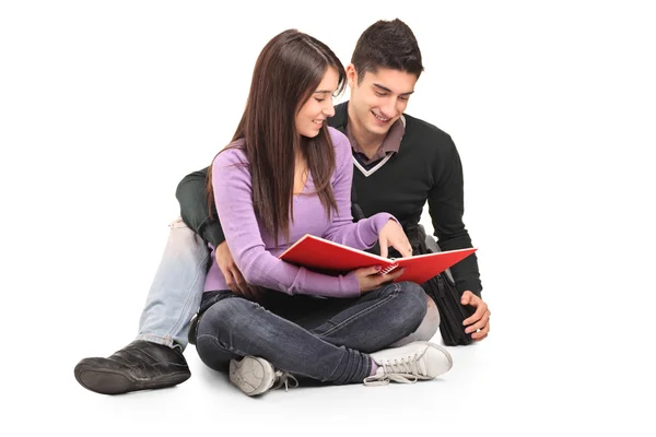 Young loving couple reading book — Stock Photo, Image